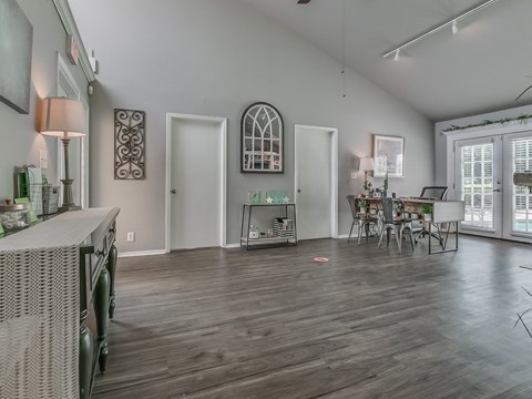 a living room with a dining room and a kitchen with a table and chairs